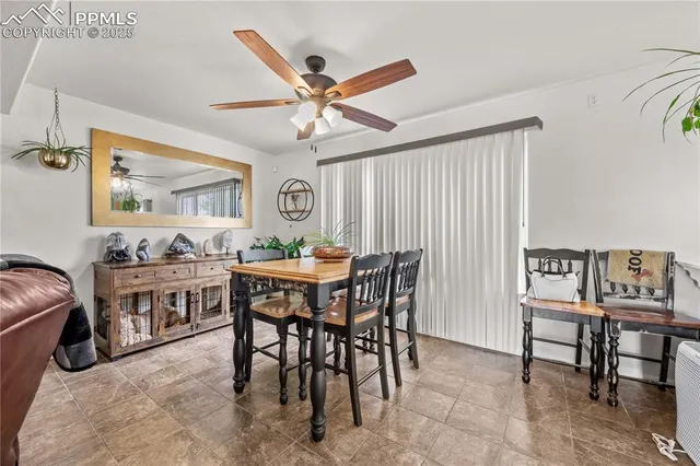 a view of a dining room with furniture and a chandelier