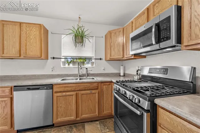 a kitchen with stainless steel appliances granite countertop a sink stove and cabinets