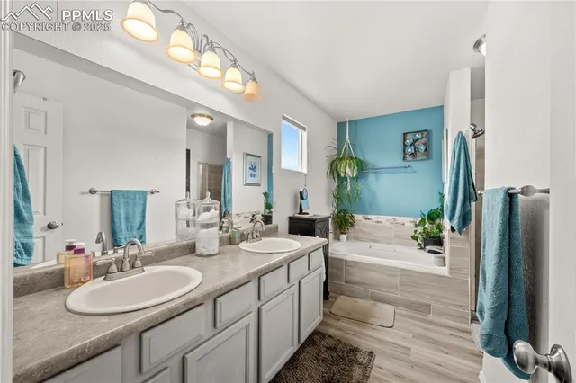 a spacious bathroom with a double vanity sink and a mirror