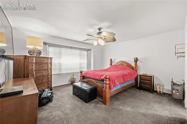 a spacious bedroom with a bed and a chandelier