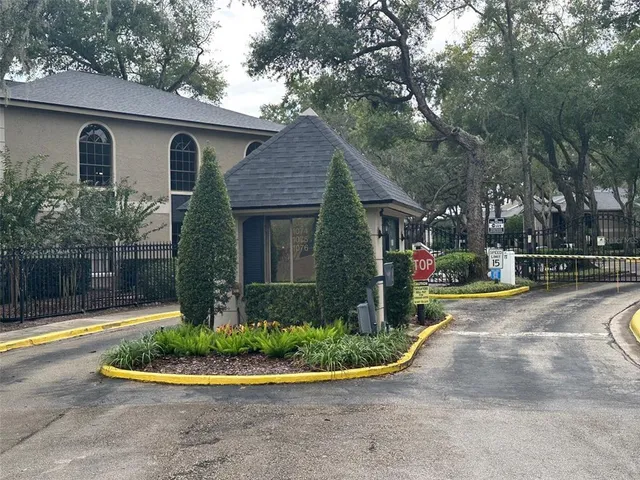 a front view of a house with a yard and potted plants
