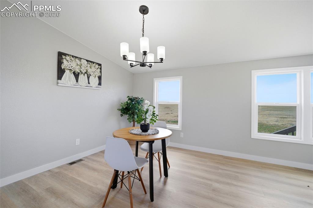 35125 Book Road Yoder, CO 80864 - Photo 20 of 45 a view of a room with furniture wooden floor and a chandelier