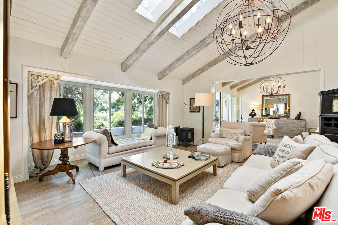 6133 Ramirez Canyon Road Malibu, CA 90265 - Photo 3 of 53 a living room with furniture a table chairs and a large window