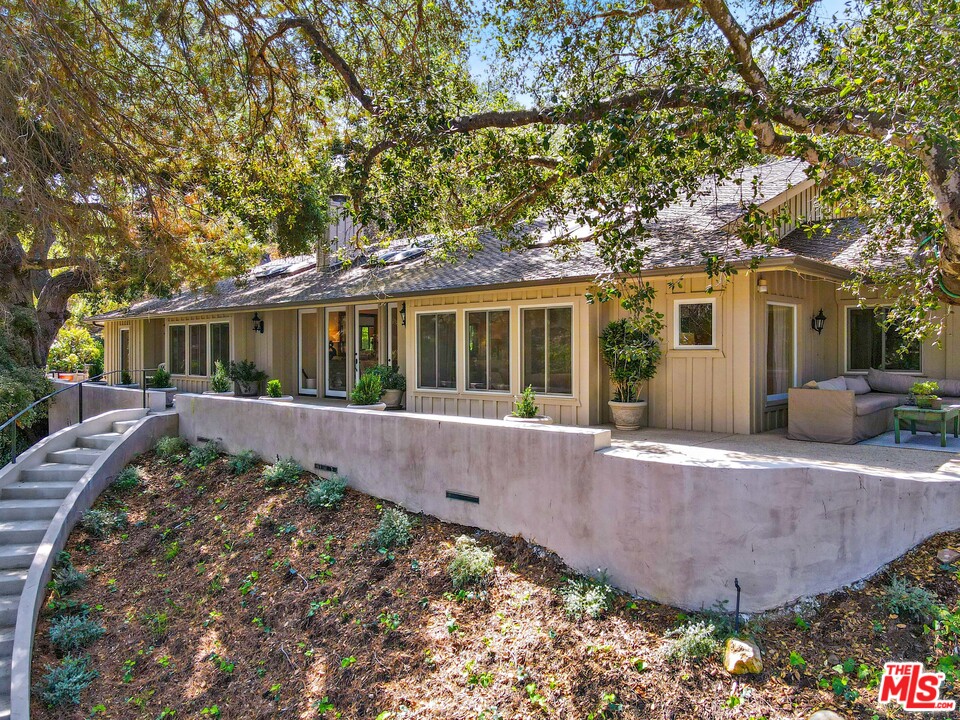 6133 Ramirez Canyon Road Malibu, CA 90265 - Photo 8 of 53 front view of a house with a garden