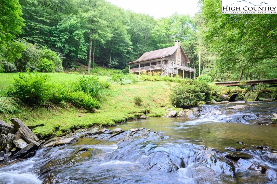 a aerial view of a house with swimming pool and a yard