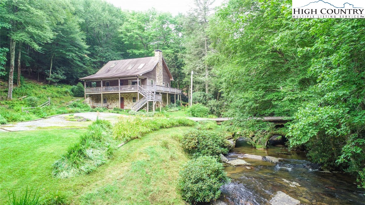 4081 Howard's Creek Road Boone, NC 28607 - Photo 2 of 44 a view of a house with a big yard plants and large trees