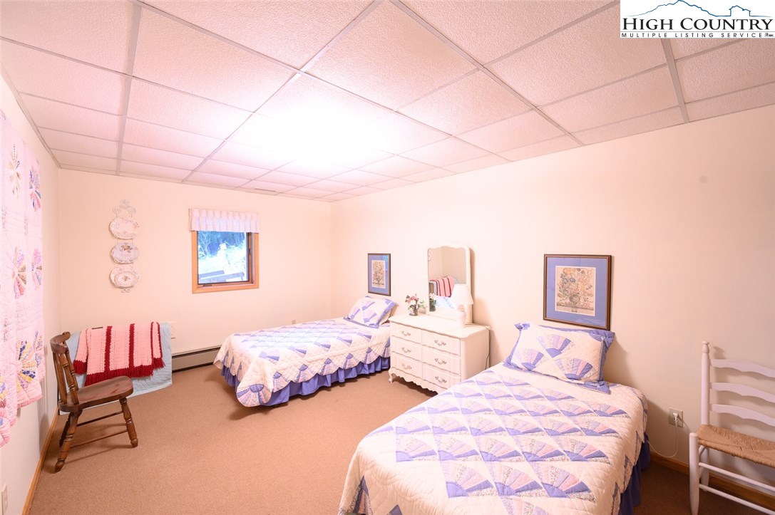 4081 Howard's Creek Road Boone, NC 28607 - Photo 27 of 44 a bedroom with two beds and a chair