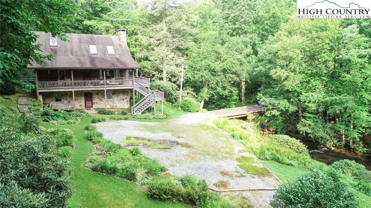 4081 Howard's Creek Road Boone, NC 28607 - Photo 44 of 44 a view of house with yard and trees in the background