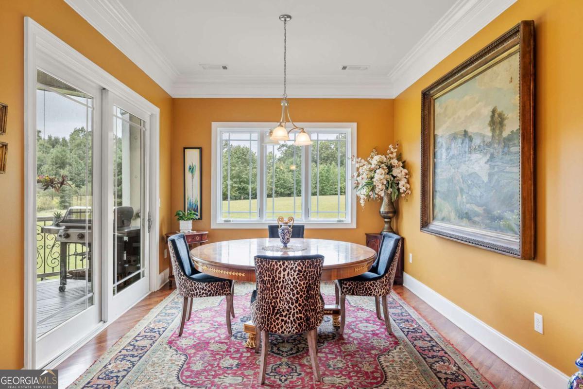 265 Honeysuckle Lane Temple, GA 30179 - Photo 17 of 46 a dining room with furniture a chandelier and wooden floor