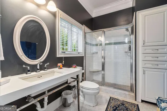 a bathroom with a sink toilet a mirror and shower