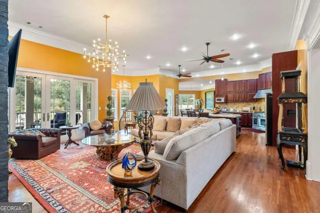 a living room with fireplace furniture and a chandelier