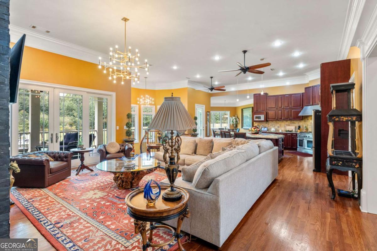 265 Honeysuckle Lane Temple, GA 30179 - Photo 3 of 46 a living room with fireplace furniture and a chandelier