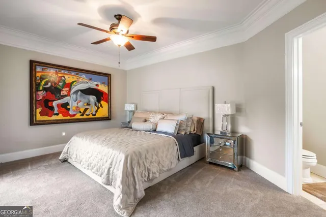 a spacious bedroom with a bed and a painting on the wall