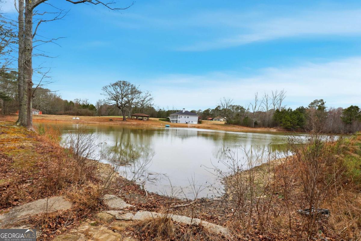 265 Honeysuckle Lane Temple, GA 30179 - Photo 39 of 46 a view of a lake with houses in the back