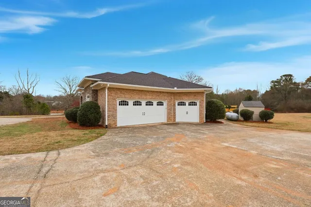 a view of a house with swimming pool and sitting area