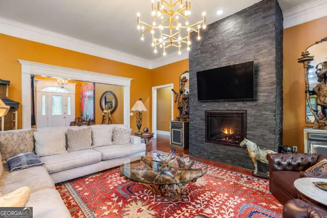 a living room with furniture a flat screen tv and a fireplace