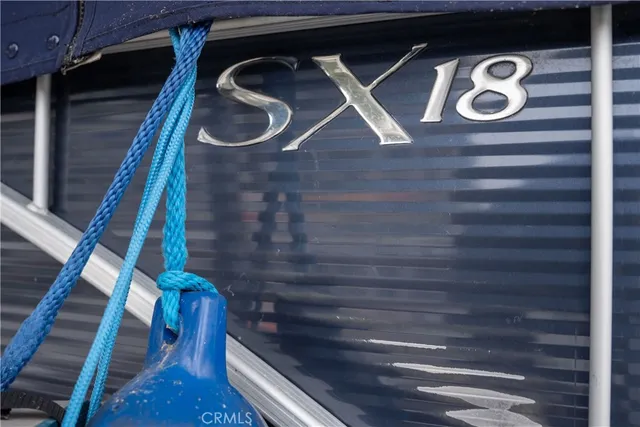a front view of a house with barbeque grill and wooden fence