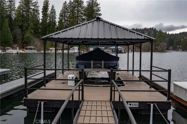 a backyard of a house with barbeque oven table and chairs