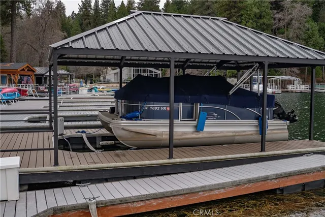 a backyard of a house with barbeque oven table and chairs
