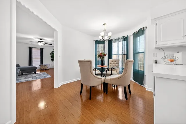 a view of a dining room with furniture and wooden floor
