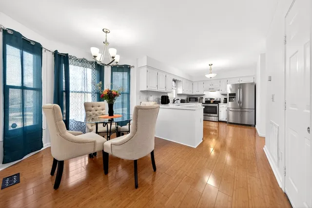 a view of a dining room with furniture window and wooden floor