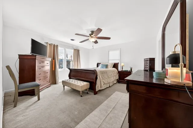 a living room with furniture flat screen tv and a large window