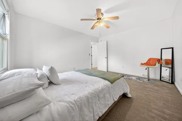 a bedroom with a bed and painting on the wall