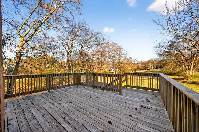 a view of balcony with wooden floor and fence