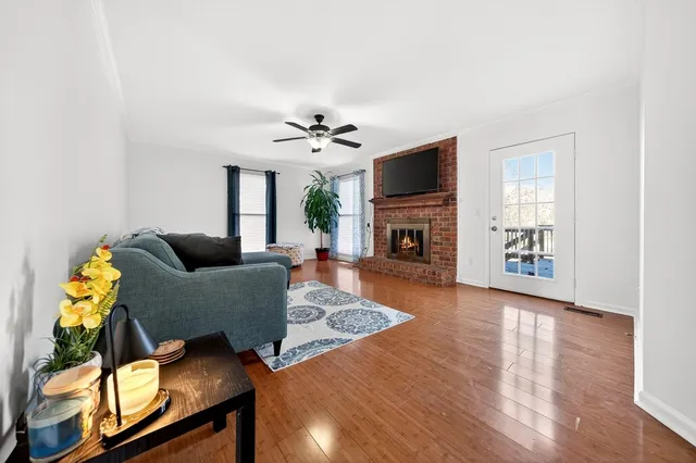 a living room with furniture a fireplace and a flat screen tv