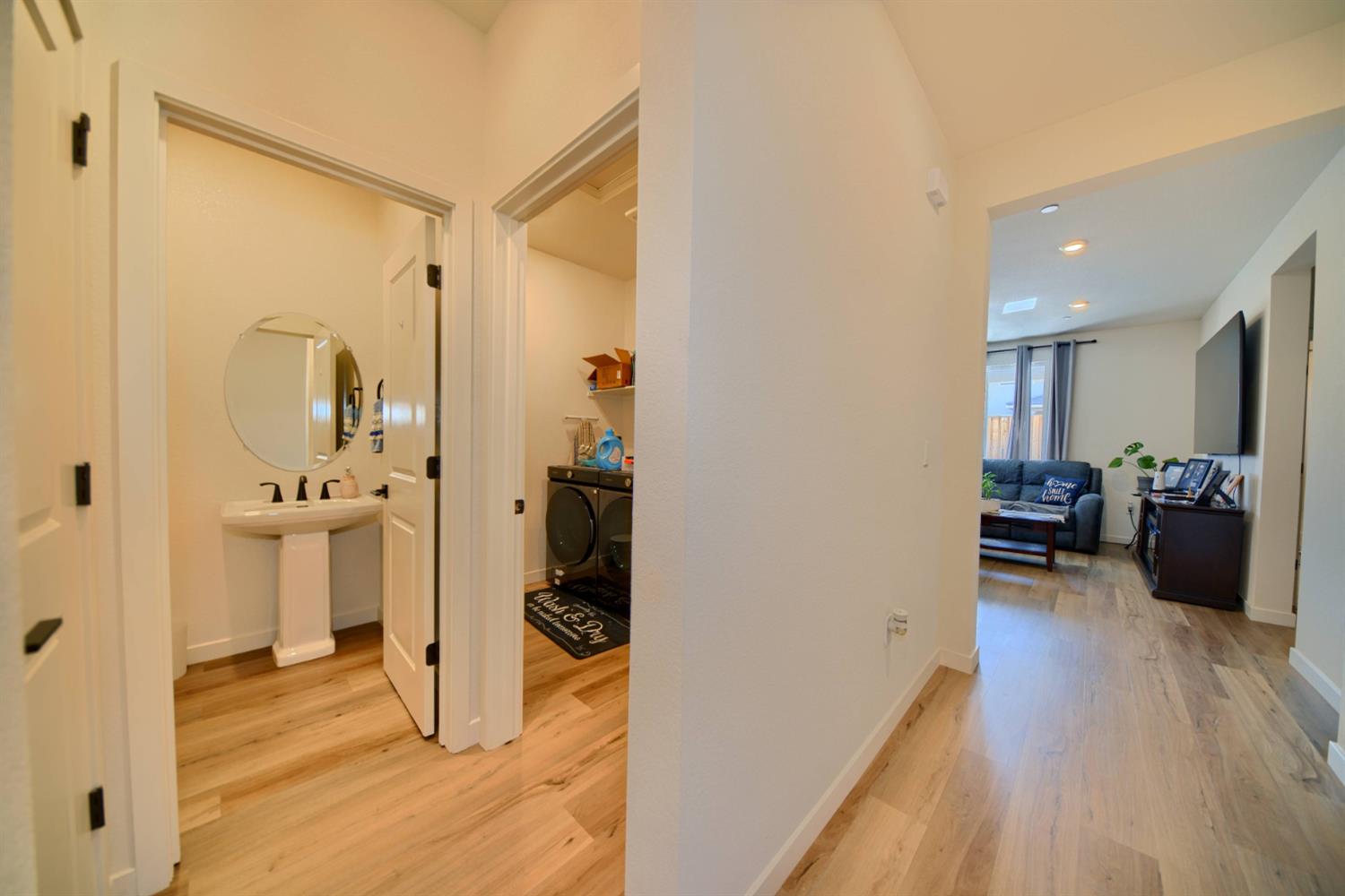 2132 Emerald Rnch Road Patterson, CA 95363 - Photo 18 of 66 a view of a hallway with wooden floor and a living room