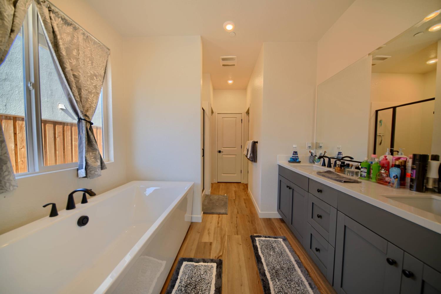 2132 Emerald Rnch Road Patterson, CA 95363 - Photo 26 of 66 a bathroom with a tub sink and mirror