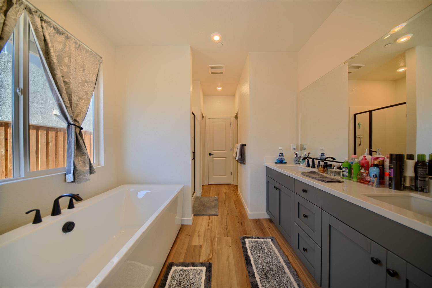 2132 Emerald Rnch Road Patterson, CA 95363 - Photo 34 of 66 a bathroom with a tub sink and mirror