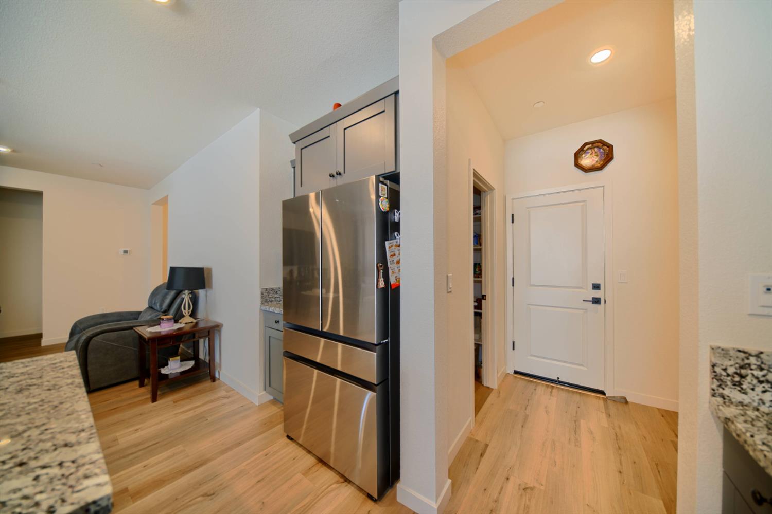 2132 Emerald Rnch Road Patterson, CA 95363 - Photo 46 of 66 a view of a refrigerator in kitchen and wooden floor