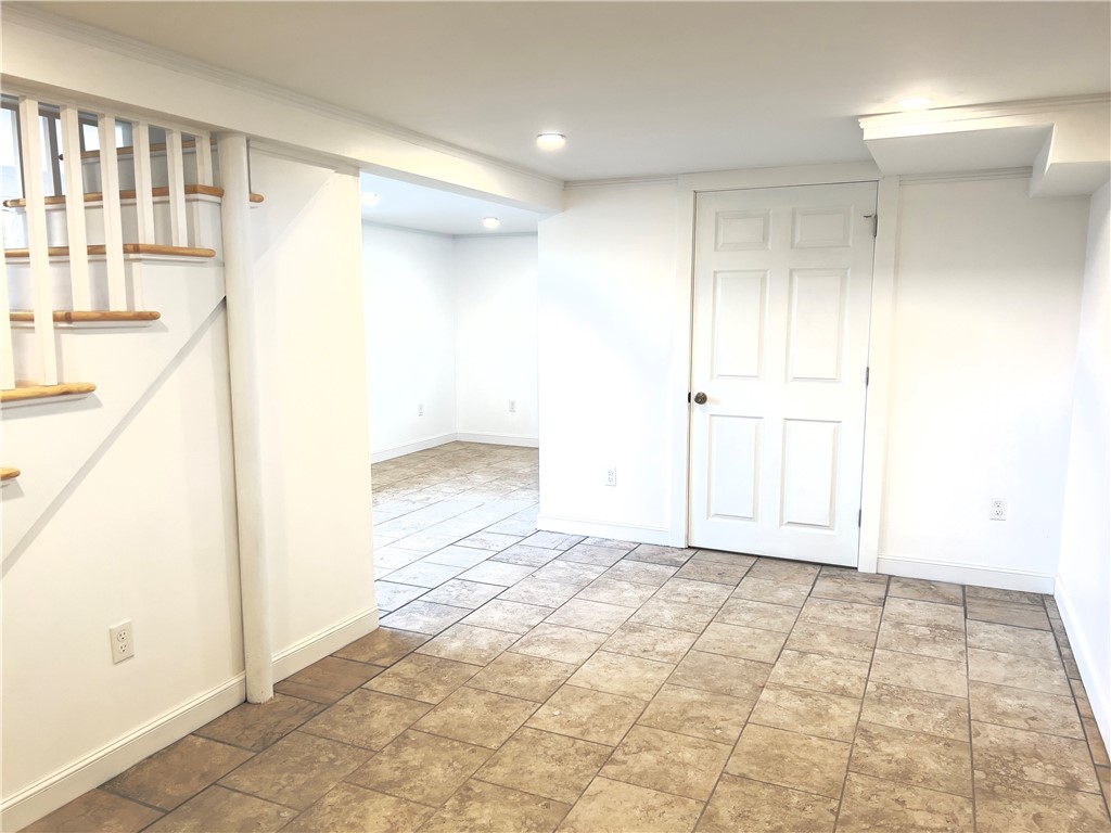 1802 Mooresfield Road South Kingstown, RI 02879 - Photo 17 of 34 Recessed lighting,tile floor all crisp and clean. Door at rear of photo is to utility room w/ Water heater and washer dryer hook up and storage.