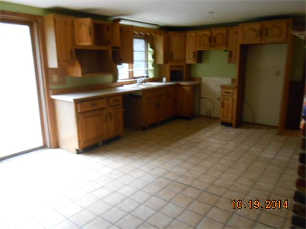 349 Erickson Road Ashby, MA 01431 - Photo 7 of 17 a kitchen with stainless steel appliances a sink stove and cabinets