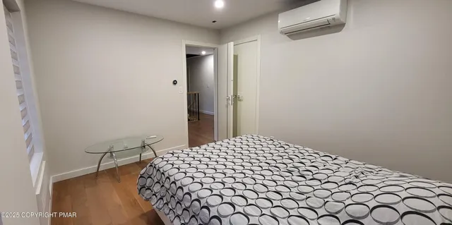 a view of a house with a yard and large tree