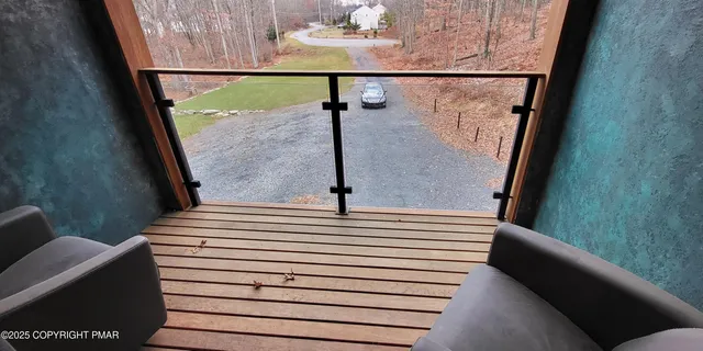 a view of a lake in between two large trees