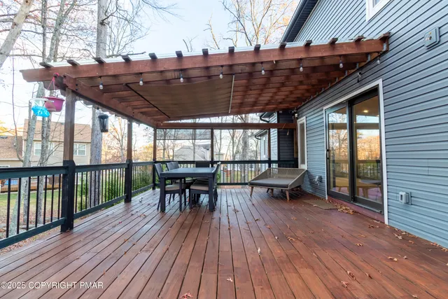 a view of a swimming pool with lawn chairs under an umbrella
