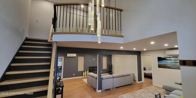 a living room with furniture and a ceiling fan