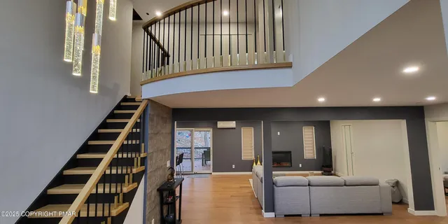 a living room with furniture and stairs