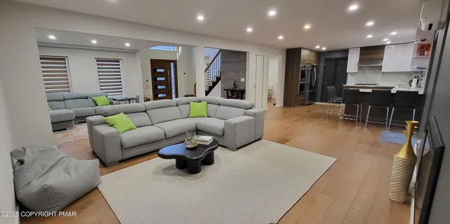 a dining room with furniture and wooden floor
