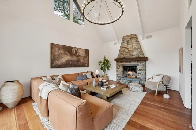 a living room with furniture a fireplace and wooden floor