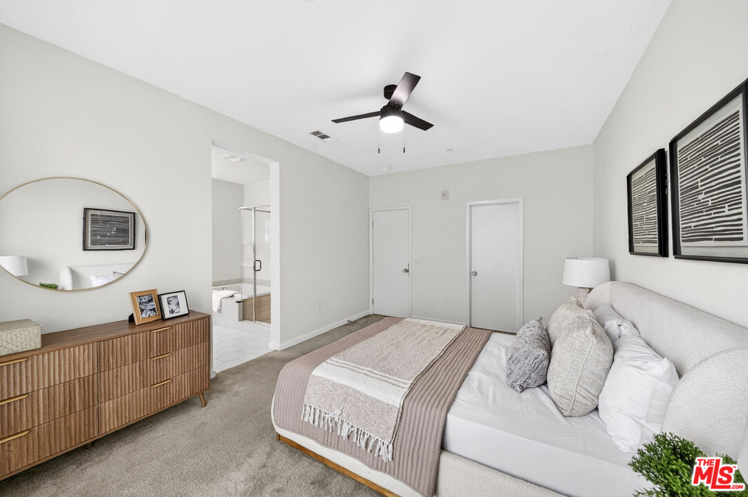 676 Colorado Circle Carson, CA 90745 - Photo 20 of 36 a bedroom with a large bed and a chandelier