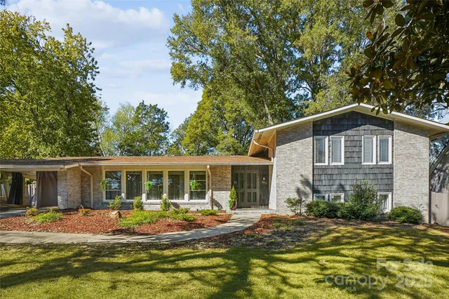 a front view of house with yard and green space