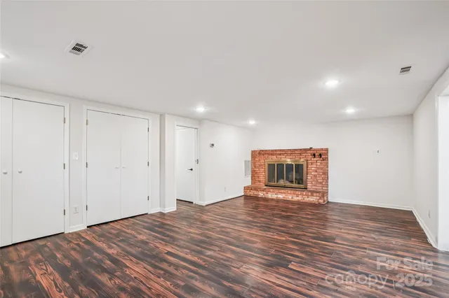 a view of a big room with wooden floor and natural light