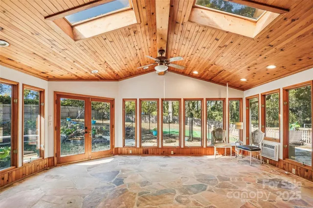 a view of a room with wooden floor and furniture