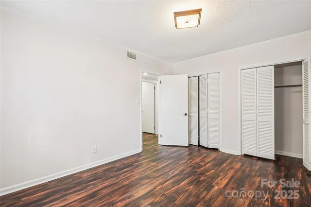 a view of a house with a wooden deck and a big yard