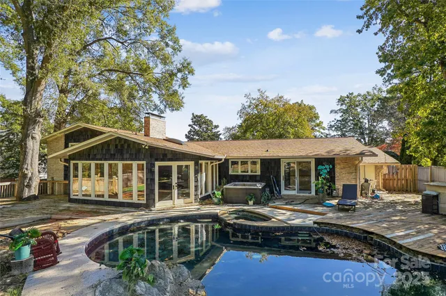 a front view of a house with swimming pool and porch