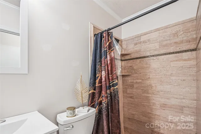 an empty room with chandelier fan