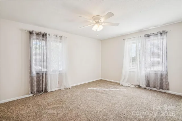a view of an empty room with closet area